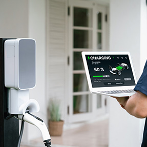 qualified-technician-working-home-ev-charging-station-installation-making-troubleshooting-configuration-setup-charging-system-with-laptop-ev-home-synchronos